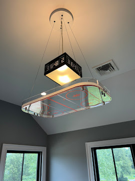 Suspended rectangular light fixture mounted to ceiling